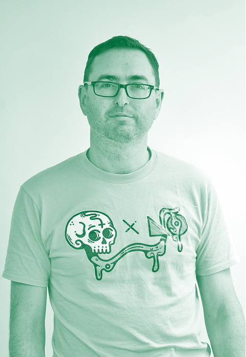 Man wearing glasses and a t-shirt with a graphic of a skull, arrow, and dripping shapes.